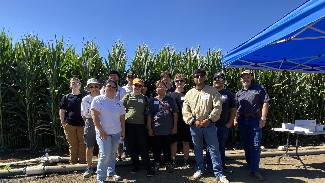 group photo in front of corn field