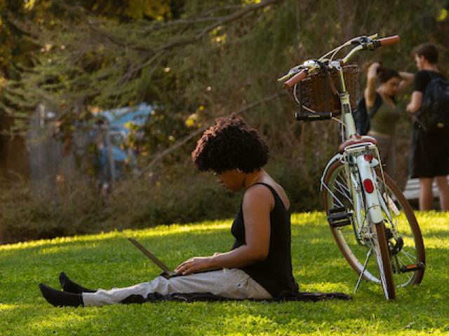 student studying with bike