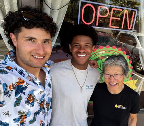 three people outside Taqueria Davis