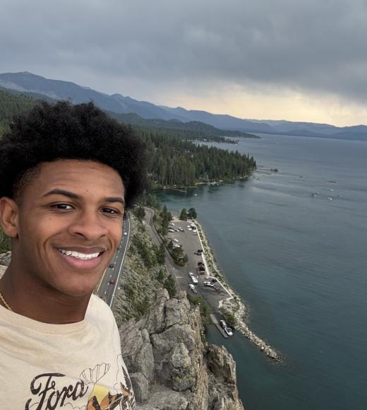 Man taking selfie in front of rugged coastline