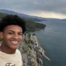 Man taking selfie in front of rugged coastline