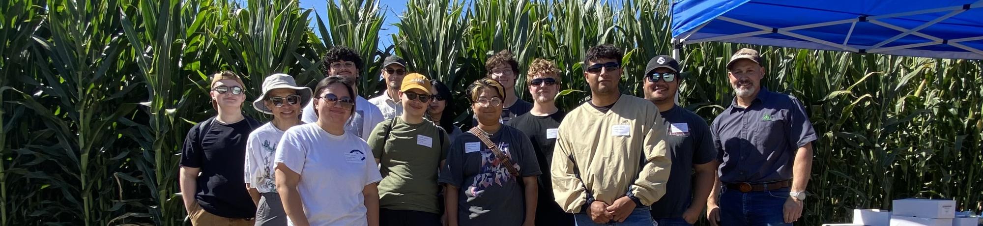 group photo in front of corn field